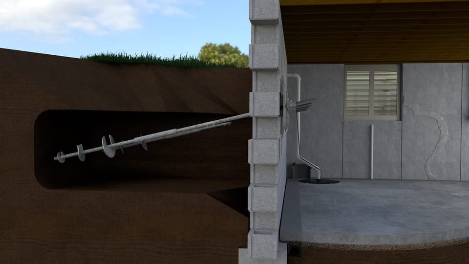 Cutaway render of a helical pier turned through the soil and bracketed to a home's stem wall