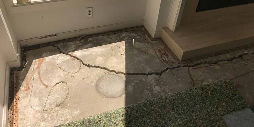 Dalinghaus Foundation Repair assessing severe concrete cracking on an interior slab floor for foundation crack repair.