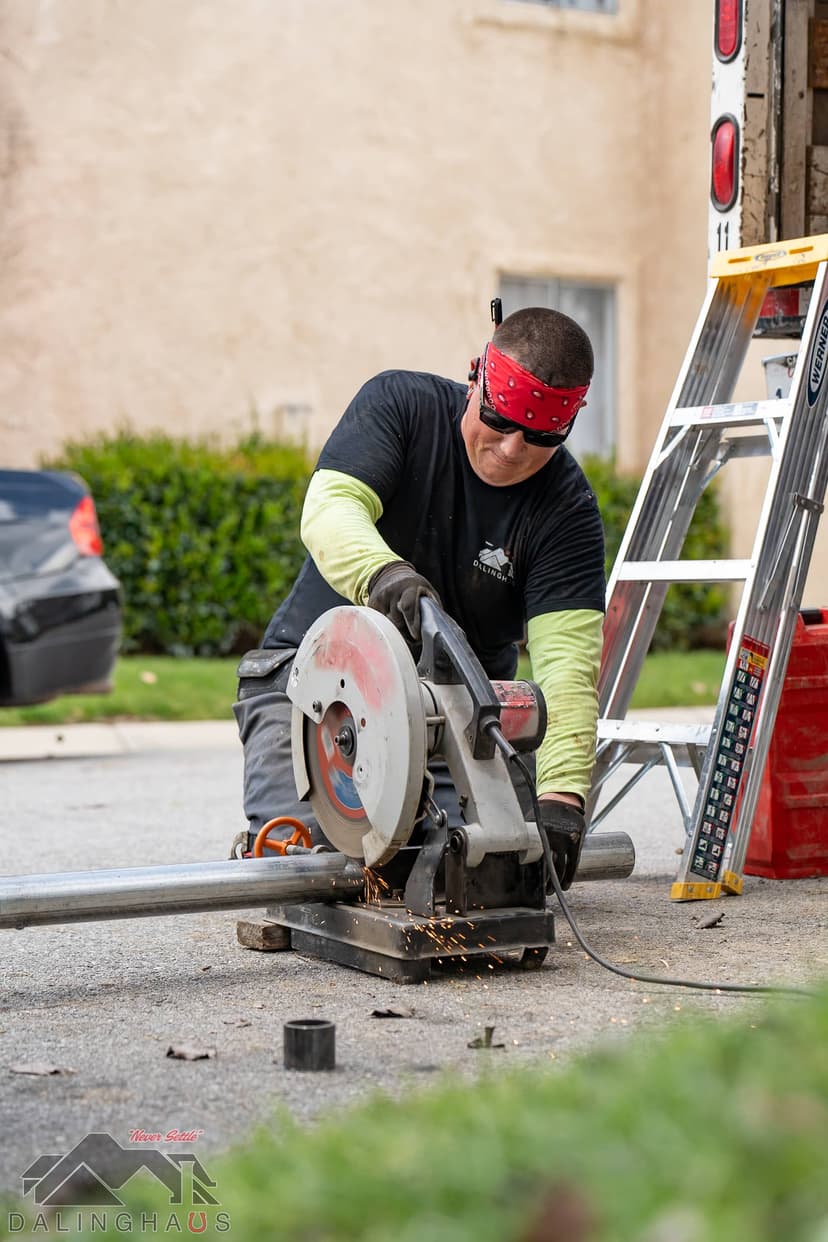 Dalinghaus Foundation Repair employee cutting steel pipe for structural foundation support.