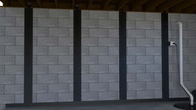 Dalinghaus Foundation Repair carbon fiber straps bonded up a concrete block wall to hold it against further movement