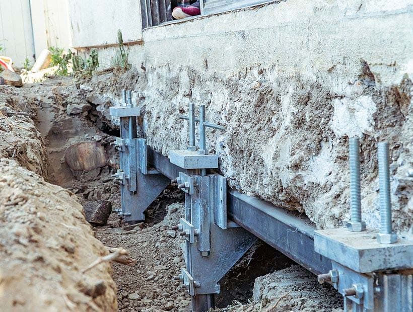 Dalinghaus Foundation Repair installing steel push piers for foundation underpinning and lifting.