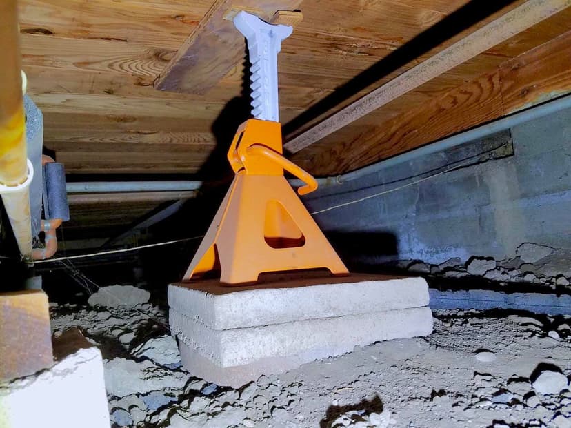 Dalinghaus Foundation Repair installing adjustable crawl space support jacks to stabilize wooden floor joists.