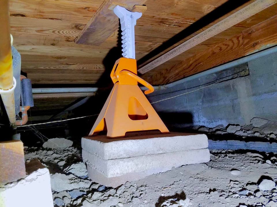 Dalinghaus Foundation Repair installing adjustable crawl space support jacks to stabilize wooden floor joists.
