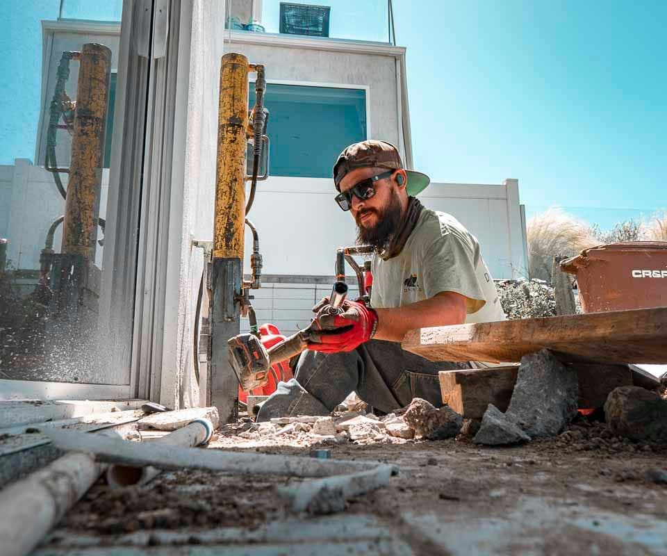 Dalinghaus Foundation Repair worker installing foundation jack equipment for structural repair.
