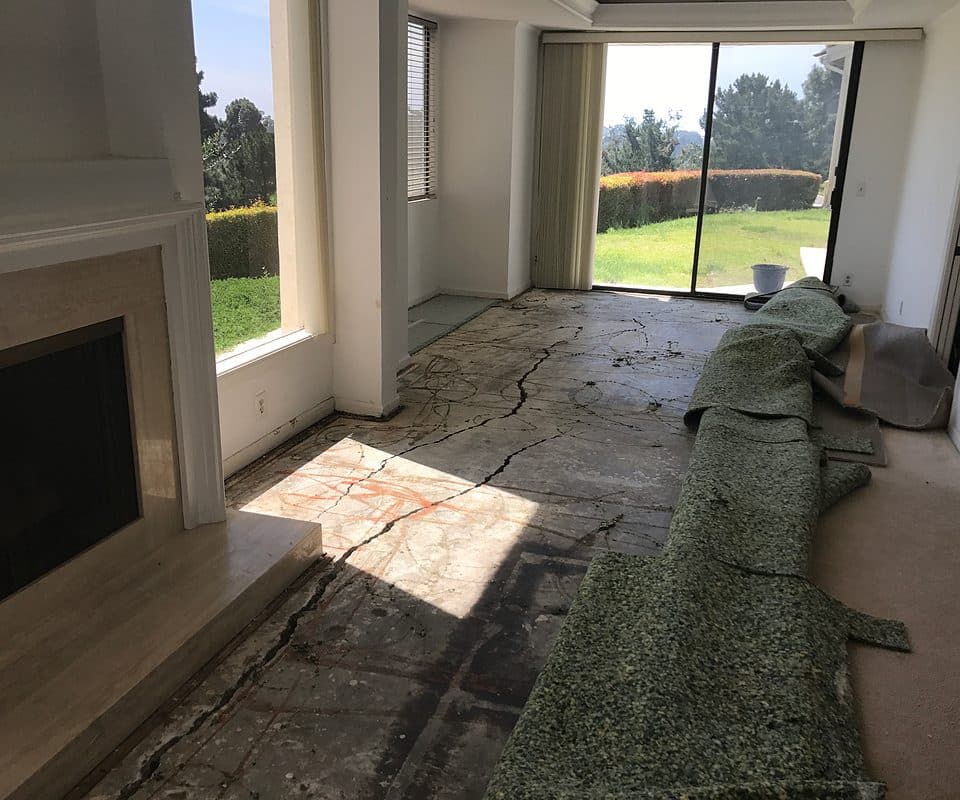 Dalinghaus Foundation Repair, a residential interior with cracked concrete floors due to foundation settling and slab