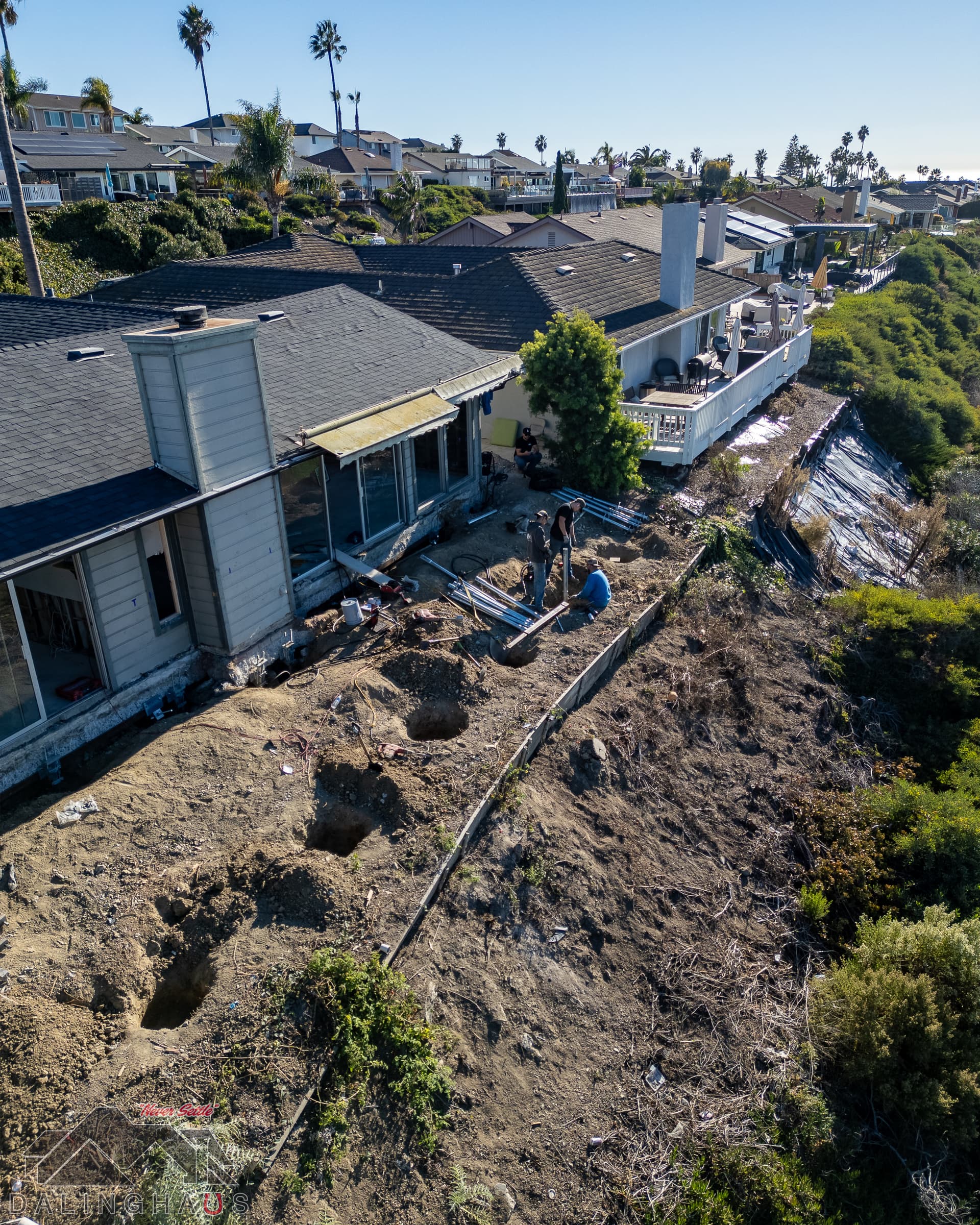 Dalinghaus Foundation Repair crew on a hillside residential project performing foundation underpinning with steel piers.