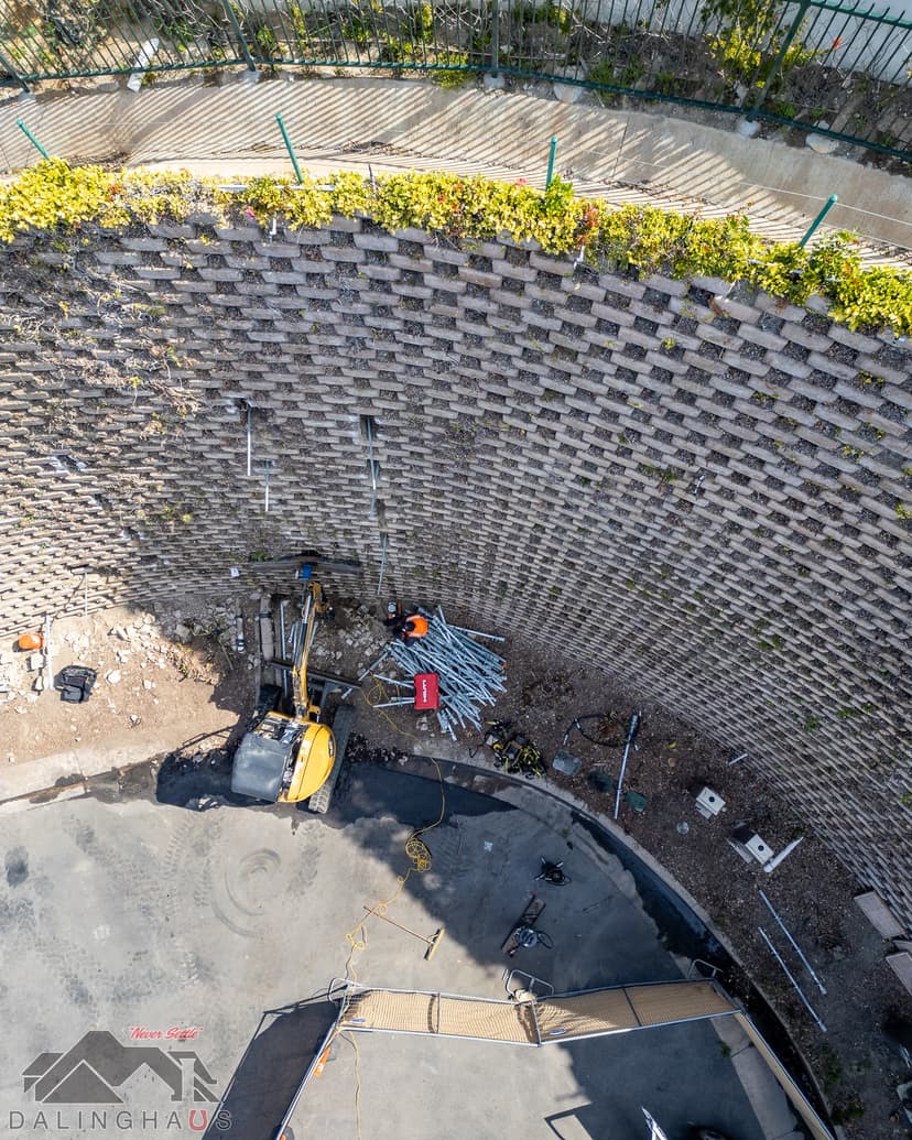 Dalinghaus Foundation Repair crew installing tieback anchors for a retaining wall stabilization project.