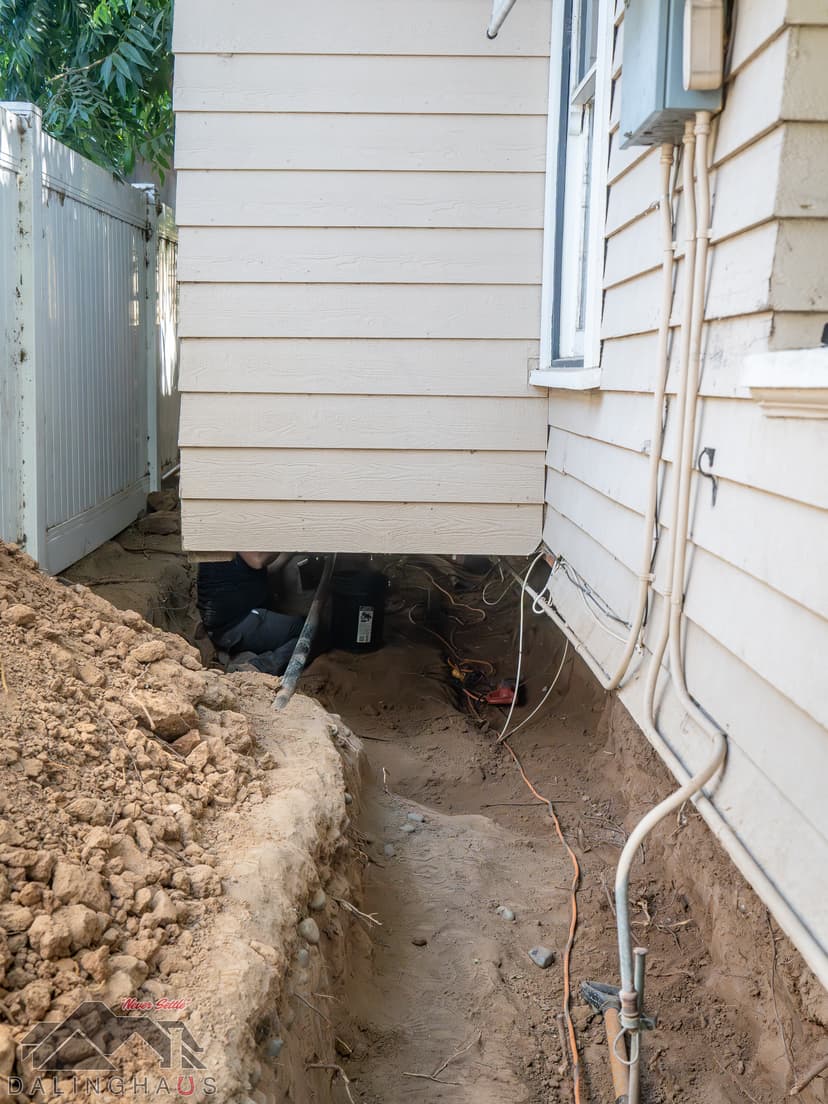 Dalinghaus Foundation Repair crew member performing crawl space structural repair during foundation digging.