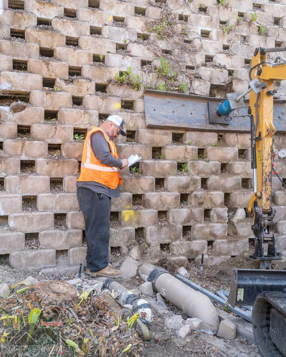 Dalinghaus Foundation Repair installing a tieback anchor system to stabilize a bowing retaining wall.