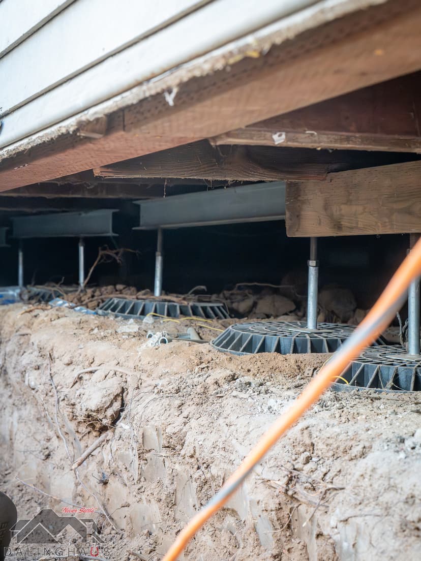 Dalinghaus Foundation Repair installing crawl space support jacks to stabilize a home's subfloor structure.
