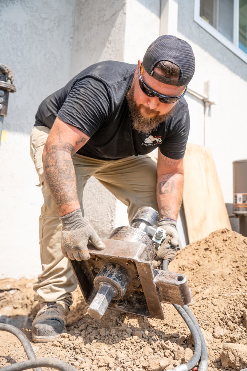 Dalinghaus Foundation Repair technician installing push piers for foundation stabilization and underpinning services.
