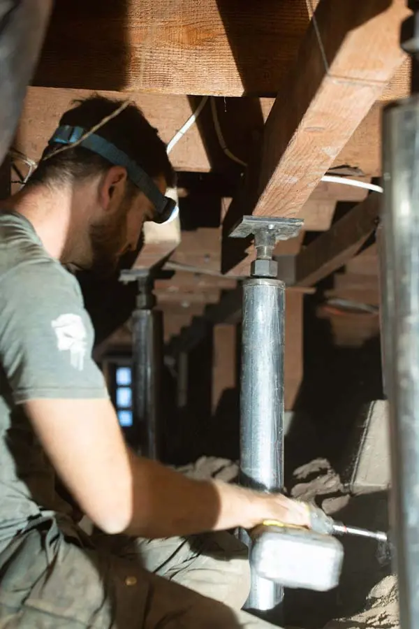 Dalinghaus Foundation Repair crew installing adjustable crawl space structural supports.