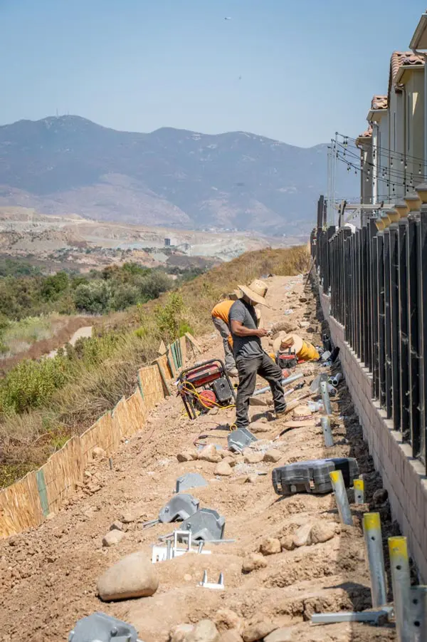 Dalinghaus Foundation Repair crew installing helical piers, a deep foundation system for hillside stabilization.