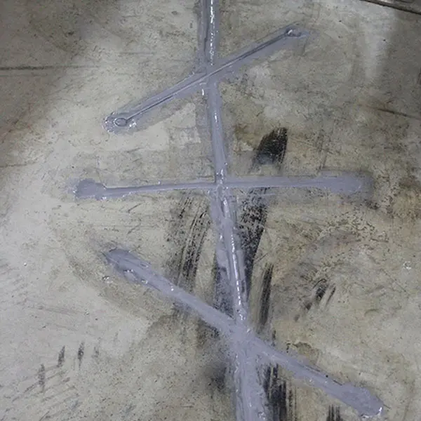 Dalinghaus Foundation Repair fixing a concrete floor crack with a stitched repair method.