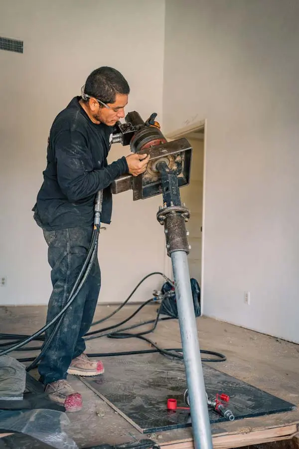 Dalinghaus Foundation Repair crew operating a drill rig for interior slab leveling and helical pier installation.