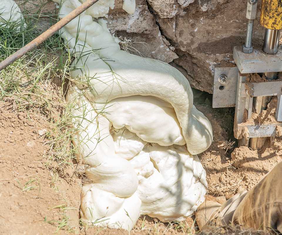 Dalinghaus Foundation Repair performing foam soil stabilization with polyurethane foam injection next to a foundation