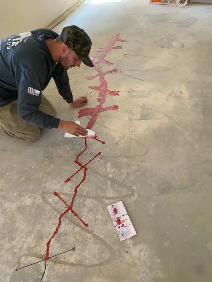 Dalinghaus Foundation Repair technician applying crack injection to a concrete slab floor.