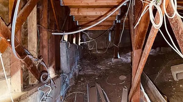 Dalinghaus Foundation Repair installing structural hardware and joist hangers in a crawl space.
