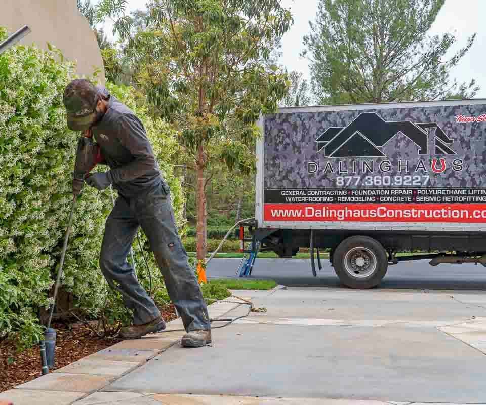 Dalinghaus Foundation Repair crew performing polyjacking, polyurethane foam injection, on a residential driveway.
