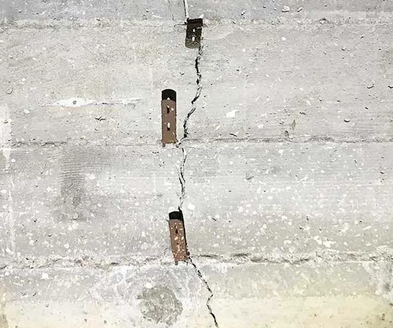 Dalinghaus Foundation Repair strengthening a concrete wall crack with stitching staples