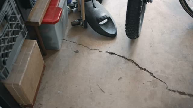 Dalinghaus Foundation Repair showing a cracked garage concrete slab, a sign of a concrete leveling problem in Costa Mesa.