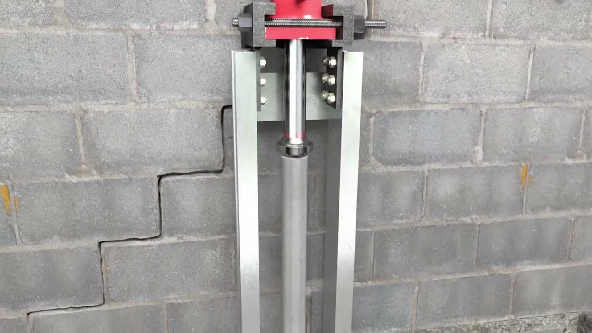 Dalinghaus Foundation Repair installing push piers with a hydraulic ram, for bowing concrete block walls with a stair-step