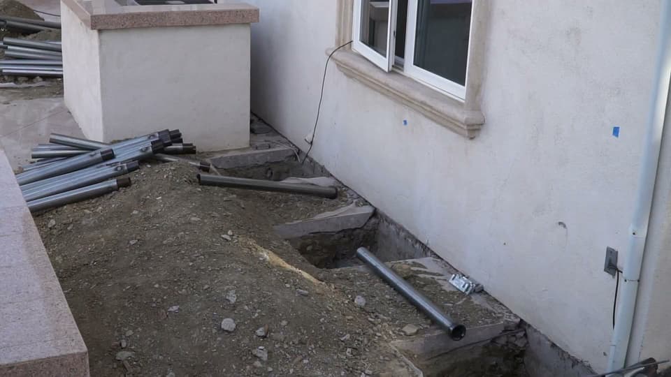 Dalinghaus Foundation Repair crew installing steel push piers for foundation underpinning with excavation in Diamond Bar