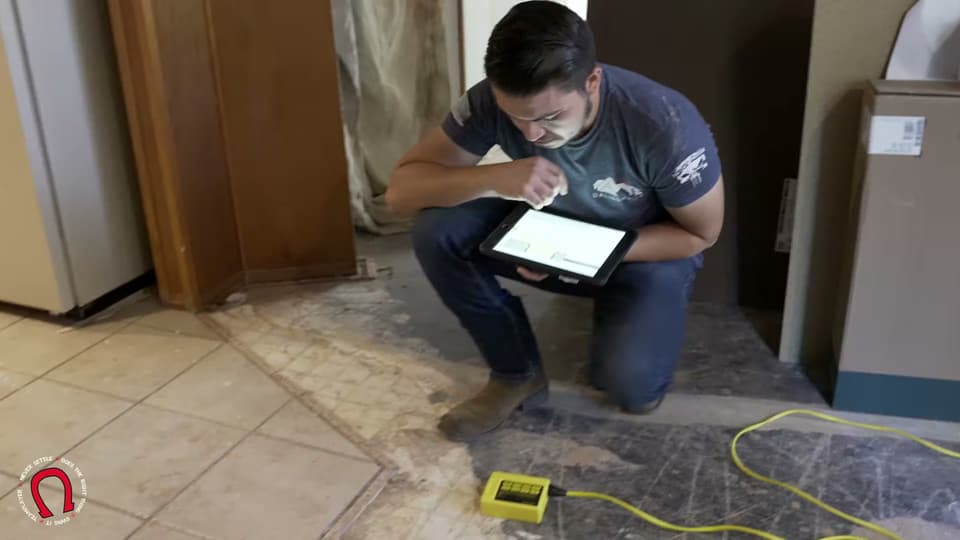 Dalinghaus Foundation Repair technician performing a foundation inspection, floor elevation measurement, and structural
