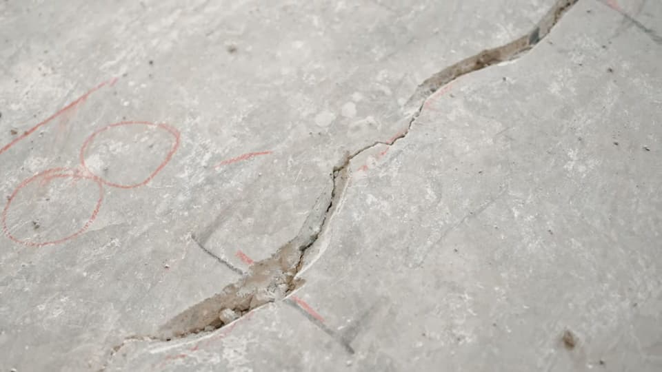 Dalinghaus Foundation Repair technician identifying a concrete slab crack for repair using crack chasing in Laguna Niguel.
