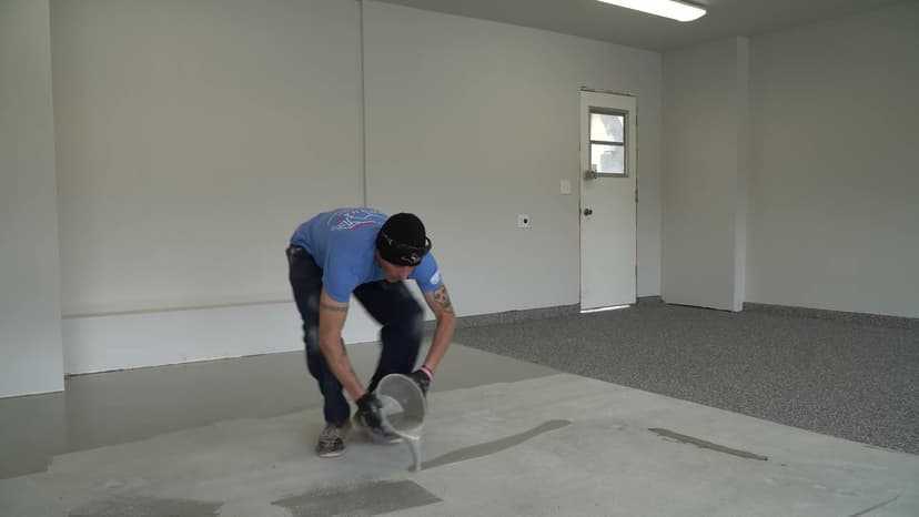 Dalinghaus Foundation Repair technician applying an epoxy coating to a garage concrete floor, part of concrete crack repair