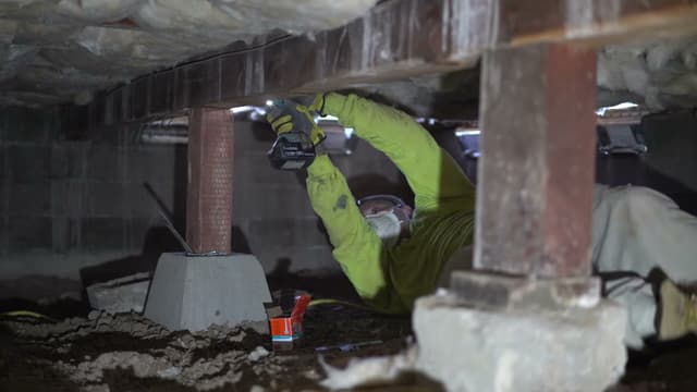 Dalinghaus Foundation Repair technician installing adjustable smart jacks for crawl space structural repair to fix sagging