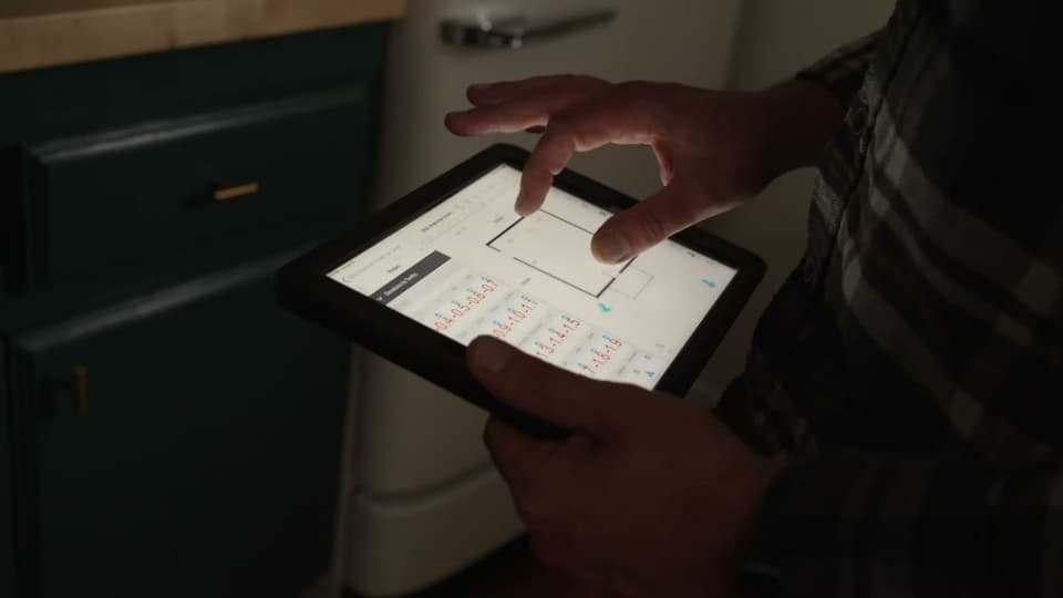 Dalinghaus Foundation Repair technician performing a structural inspection with a digital tablet.