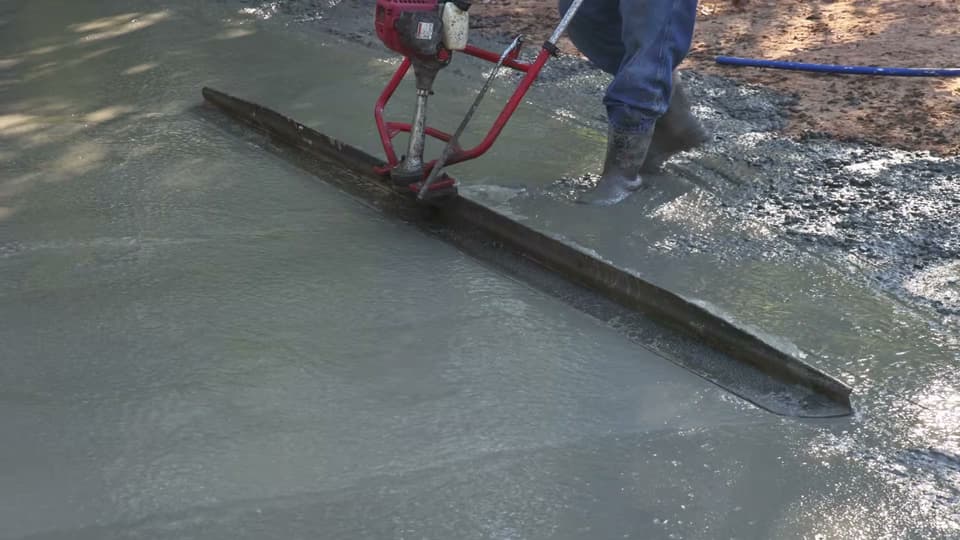 Dalinghaus Foundation Repair crew member using a power screed to level freshly poured concrete, Why