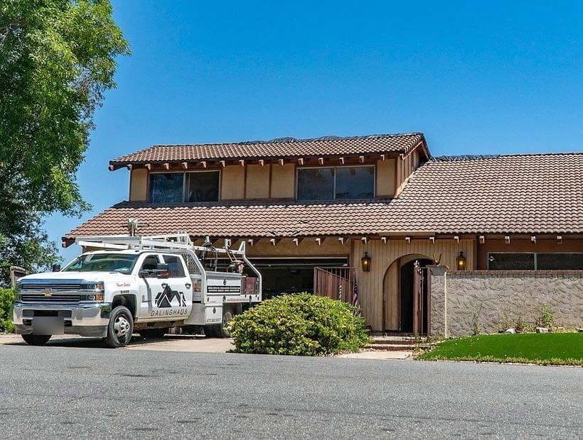 White Dalinghaus crew truck parked at a two story tan stucco home with a tile roof and arched entry