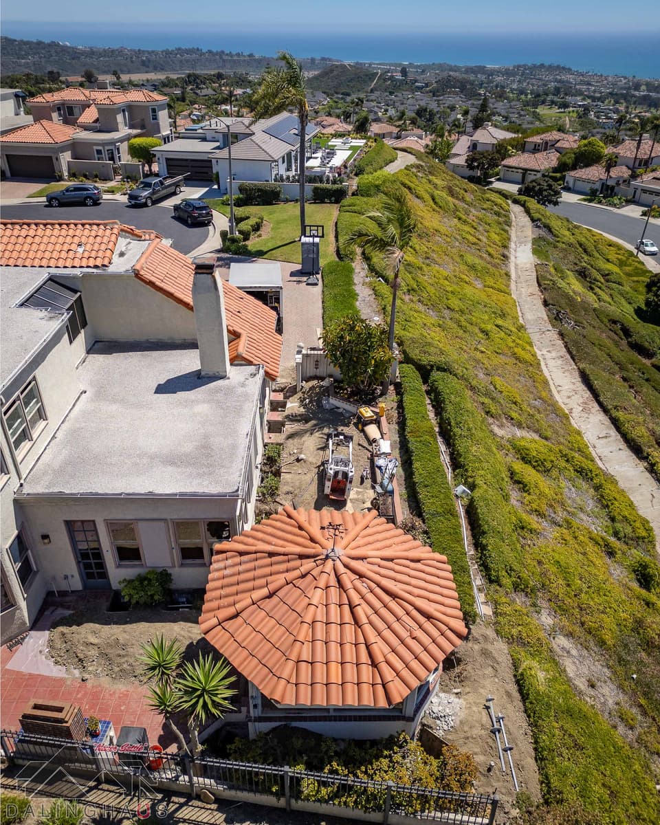 Top down view of the sunroom’s octagonal tile roof with a track loader and helical shafts alongside