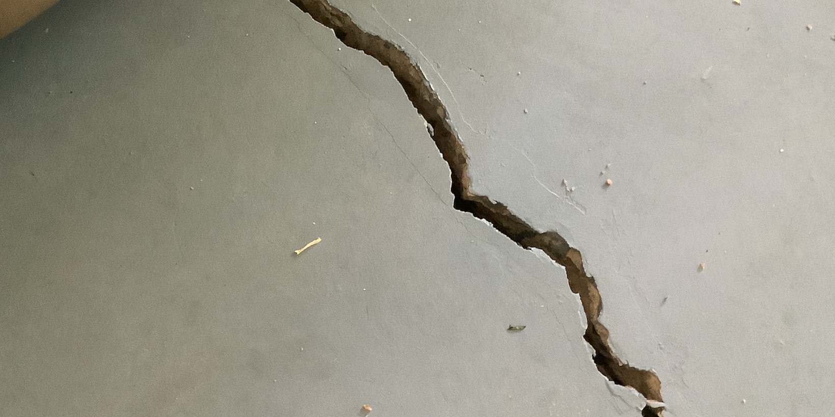 How Foundation Settlement Causes Garage Floor Cracks (Uneven Support, Voids & Repair)