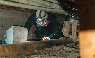 man replacing concrete pad in crawlspace