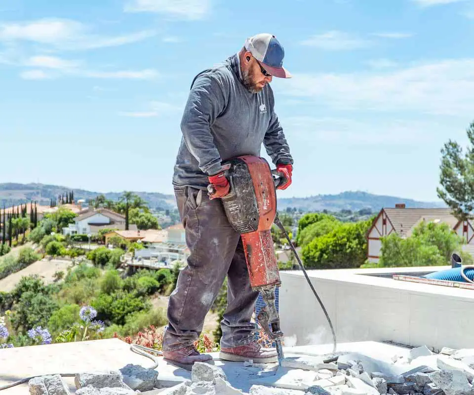 Dalinghaus crew member breaking out concrete on a hillside jobsite