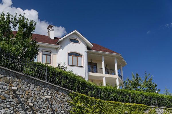 Retaining walls are not just for show; they serve several important purposes, especially if you have a sloped yard.