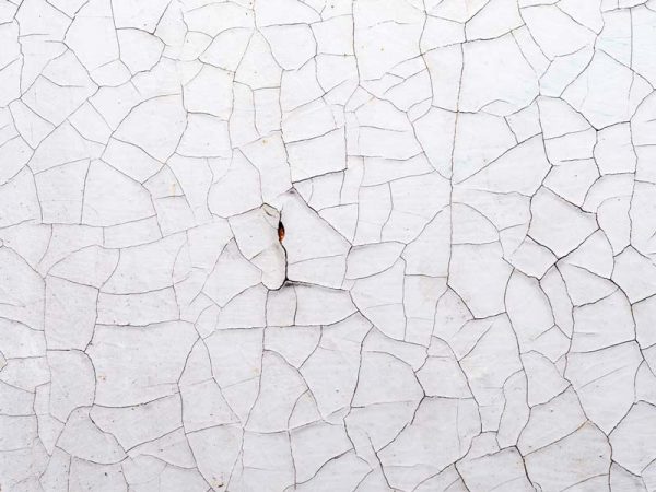 Background of a white surface in cracks Stucco Cracking