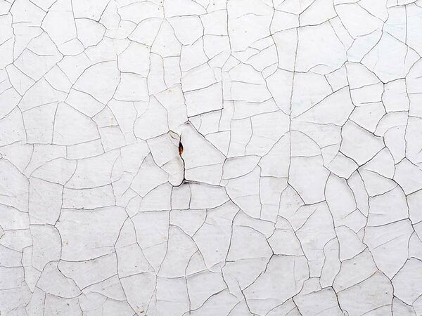 Background of a white surface in cracks Stucco Cracking